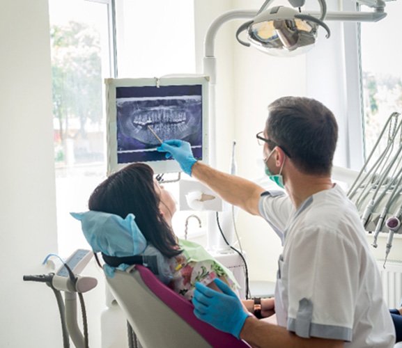 showing woman x-ray at dental exam in Dallas     