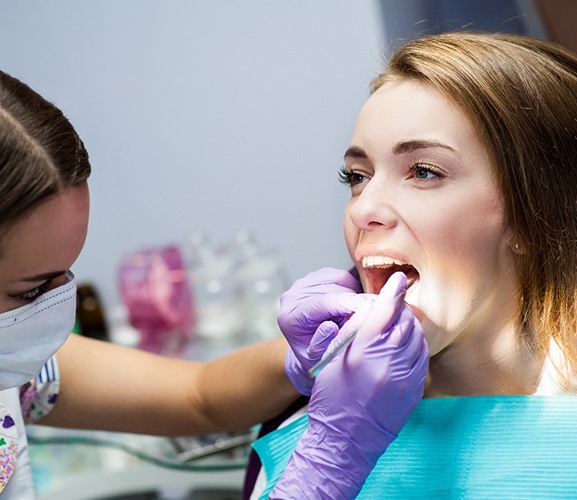 A woman receiving dental crowns in Dallas