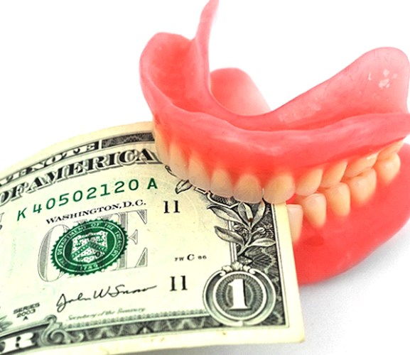 Top and bottom dentures with money between them