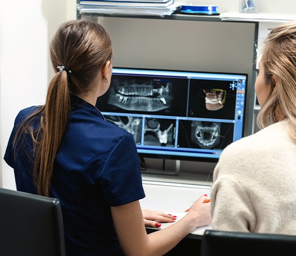 Dental team members looking at digital smile x-rays