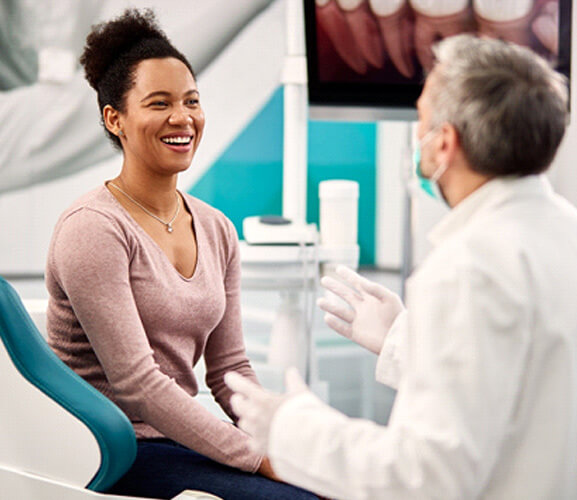 a patient consulting with her dentist about cosmetic dental bonding