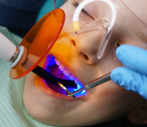 Child receiving dental sealants