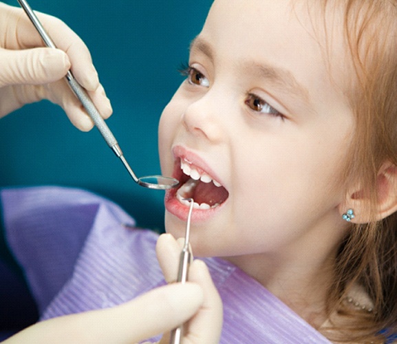 A young girl having her teeth checked by a trusted dental professional