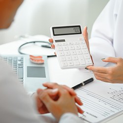 a dentist and patient discussing the cost of cosmetic dentistry  