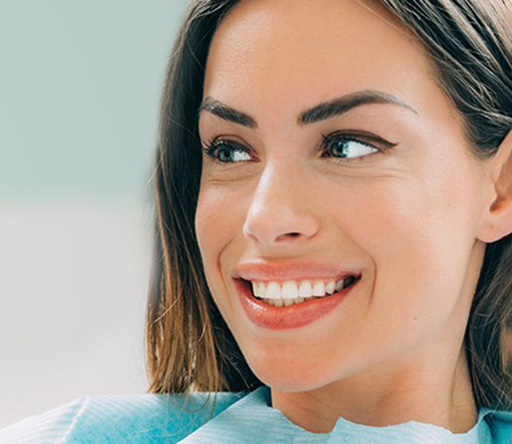 a patient smiling after receiving cosmetic dentistry 