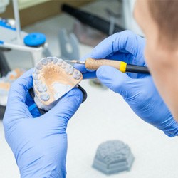 Lab technician carving dentures