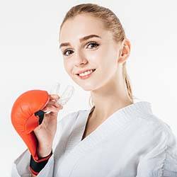 Lady boxer wearing mouthguard to prevent dental emergencies in Dallas