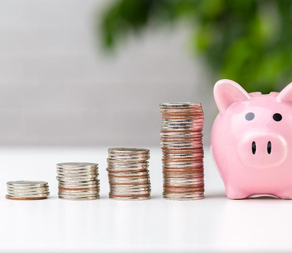 Coins stacked by piggy bank