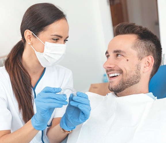 Dallas dentist and patient discussing Invisalign in Dallas