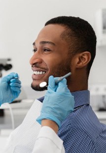 a patient visiting his dentist near Farmer’s Branch