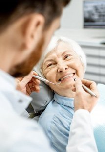 a patient smiling after replacing missing teeth near Farmer’s Branch