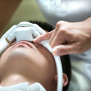 Closeup of dentist pointing to nasal mask on patient