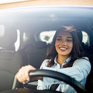 Woman smiling while driving home