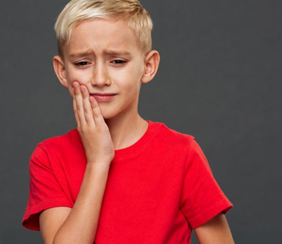 Frowning young boy with a toothache