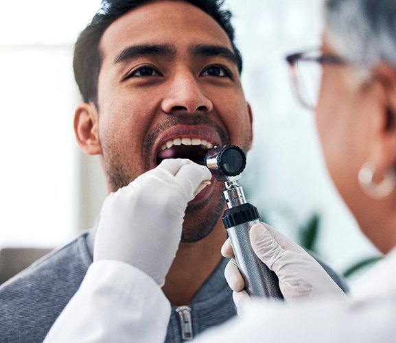 Man having his mouth examined