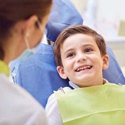 young boy smiling at his dentist 