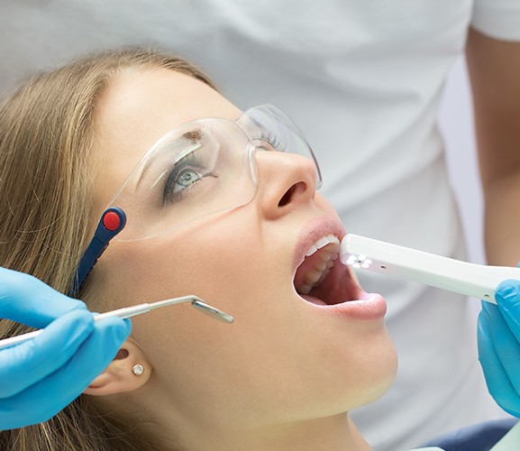 Dentist using intraoral camera to capture smile images