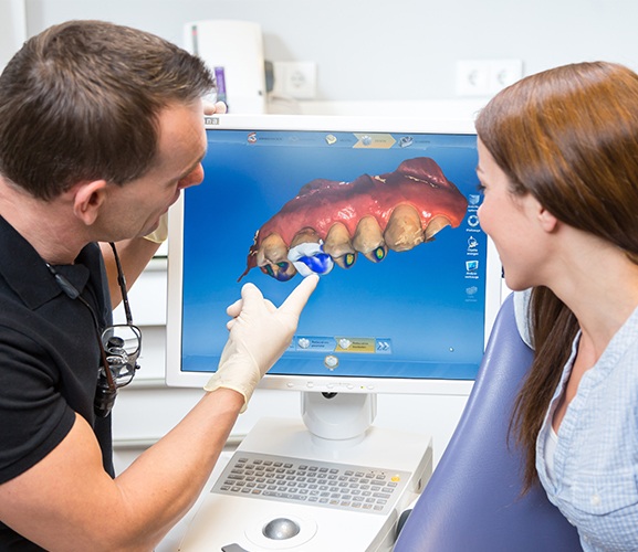 Dentist and patient looking at digital impressions