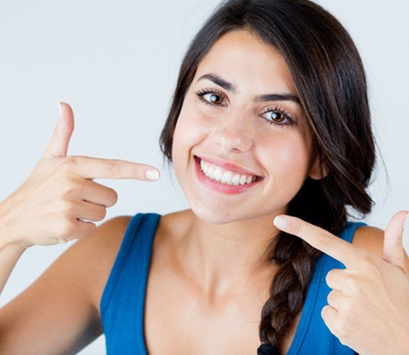 woman smiling after getting veneers in Dallas