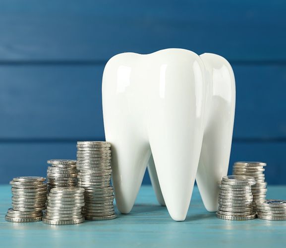 Metal coins surrounding a large ceramic tooth