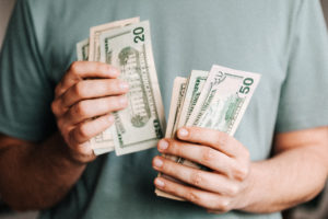 Man counting cash for the cost of braces