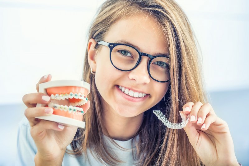 Braces and aligners, each of which is an example of a holistic orthodontic treatment
