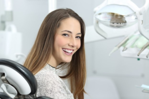 patient smiling while visiting their dentist