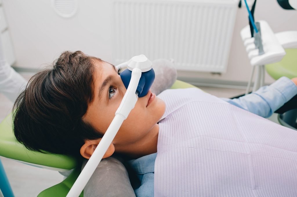 child at dentist receiving nitrous oxide sedation